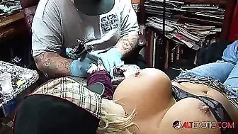 Shyla Stylez gets tattooed while playing with her tits